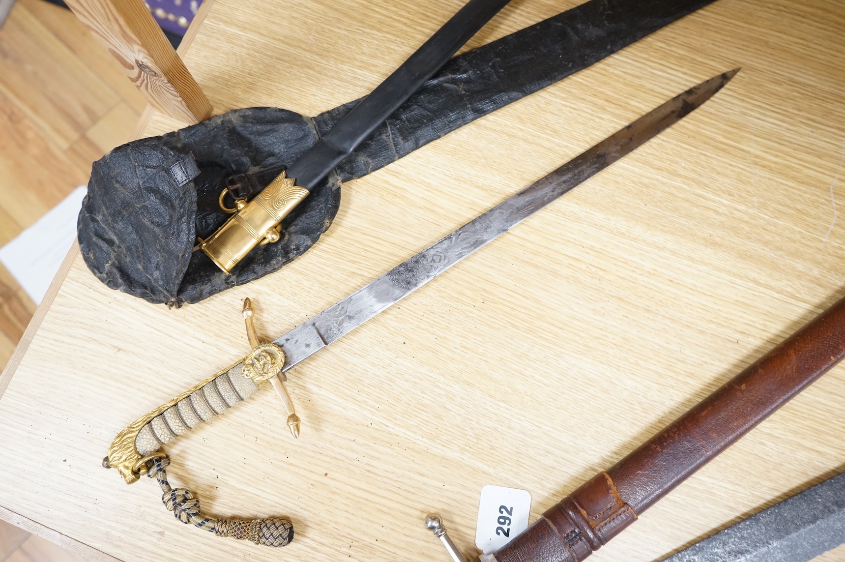 A post 1902 regulation Naval Officer’s dirk with lion’s head pommel, bullion dress knot, shark skin covered grip, in its leather scabbard, the gilt locket engraved with owners initials; CHCO’ R, the blade etched with cro